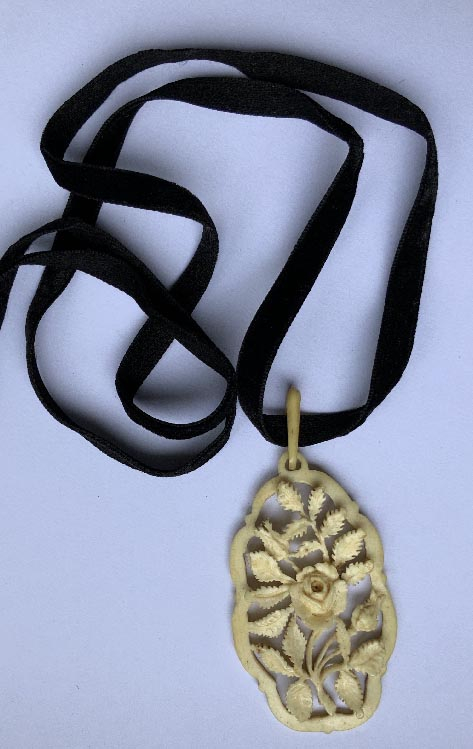 Victorian necklace with carved bone pendant and long velvet ribbon